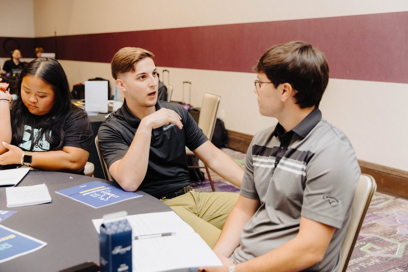 Trevor Amrein in conversation with attendees at a round table